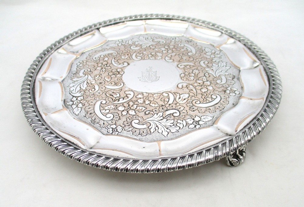 A circular Regency period Old Sheffield plated card tray featuring an engraved floral surface, armorial crest centre, pie-crust rim, and rope-twist border. View III