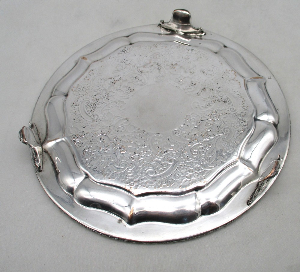 A circular Regency period Old Sheffield plated card tray featuring an engraved floral surface, armorial crest centre, pie-crust rim, and rope-twist border. View VII