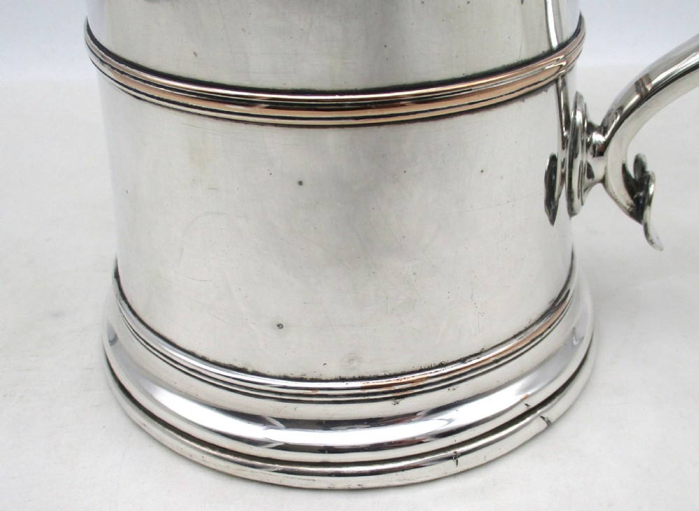 A Georgian Old Sheffield silver-plated quart tankard featuring a tapered body with a central girdle, moulded foot, and C-scroll handle. View III