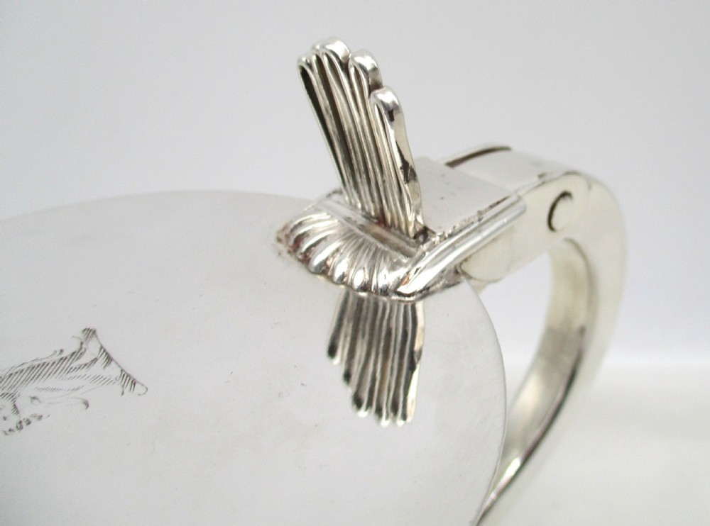 A silver-plated lidded tankard featuring a hinged lid with a thumbpiece, horizontal reeded banding, and a glass base. View III