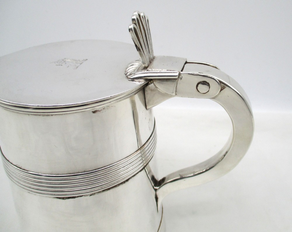A silver-plated lidded tankard featuring a hinged lid with a thumbpiece, horizontal reeded banding, and a glass base. View IV