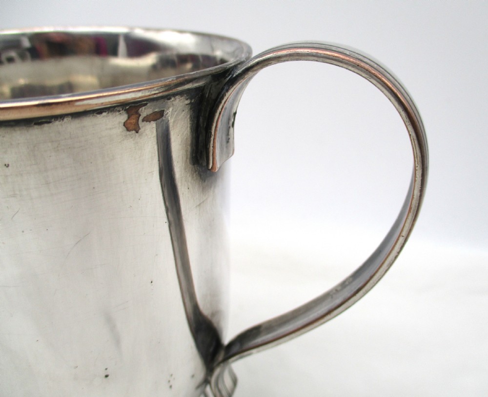 A Georgian silver-plated two-handled cup featuring a flared pedestal foot, looped side handles, and a central engraved crest. View VI