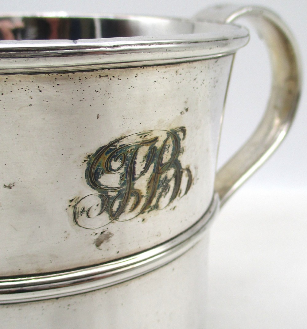 An antique silver-plated two-handled loving cup featuring a central girdle band, moulded foot, and an engraved monogram. View II