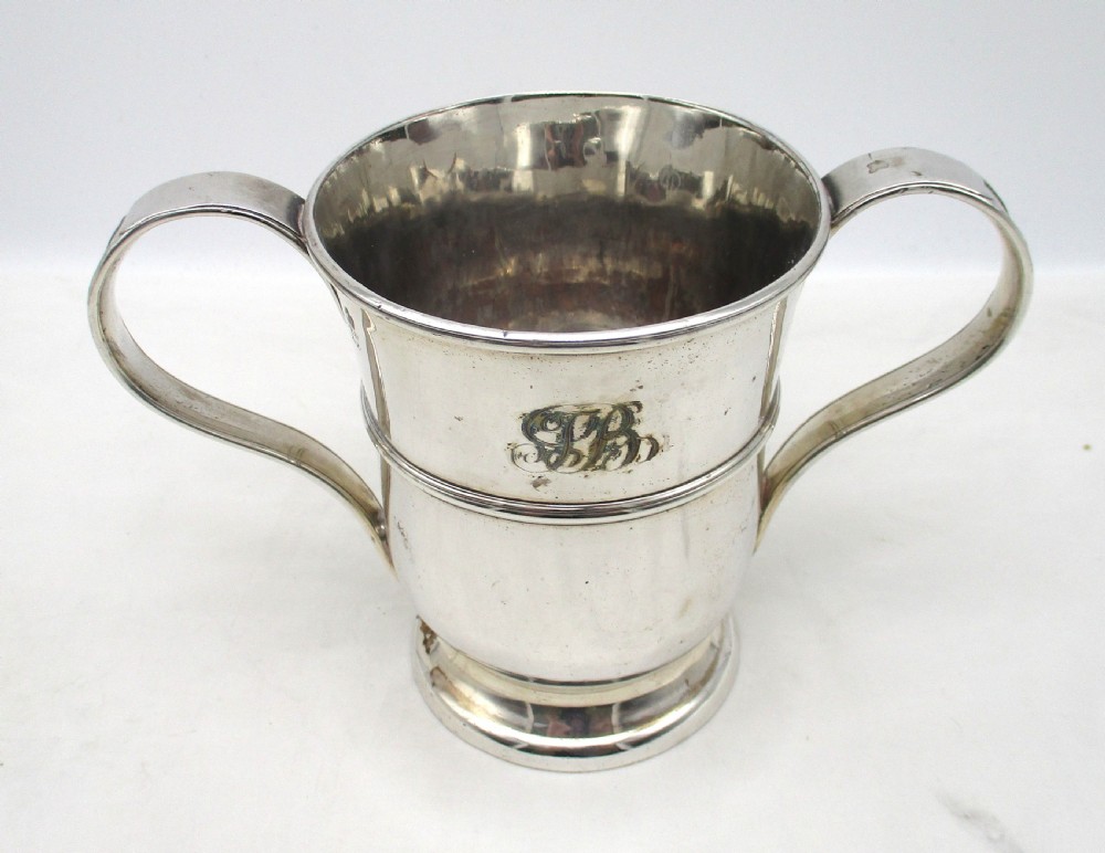 An antique silver-plated two-handled loving cup featuring a central girdle band, moulded foot, and an engraved monogram. View III