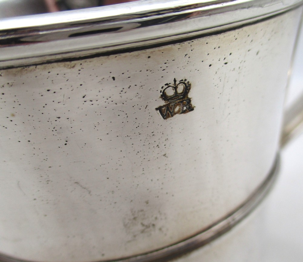 An antique silver-plated two-handled loving cup featuring a central girdle band, moulded foot, and an engraved monogram. View IX