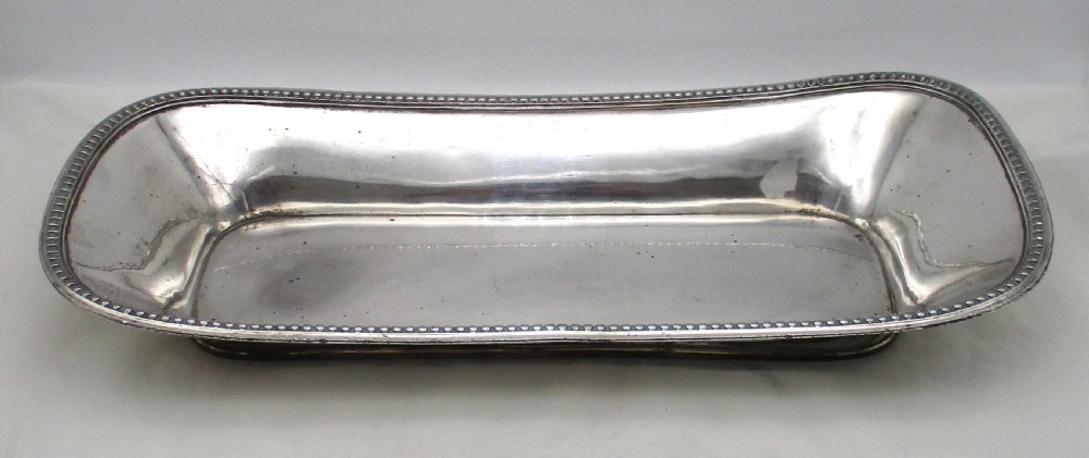An elongated 19th-century Old Sheffield silver-plated tray featuring a rectangular form with rounded ends and a beaded outer rim. View II