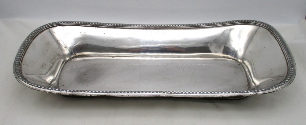 An elongated 19th-century Old Sheffield silver-plated tray featuring a rectangular form with rounded ends and a beaded outer rim. View III