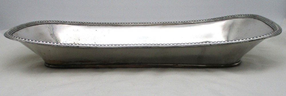 An elongated 19th-century Old Sheffield silver-plated tray featuring a rectangular form with rounded ends and a beaded outer rim. View IV