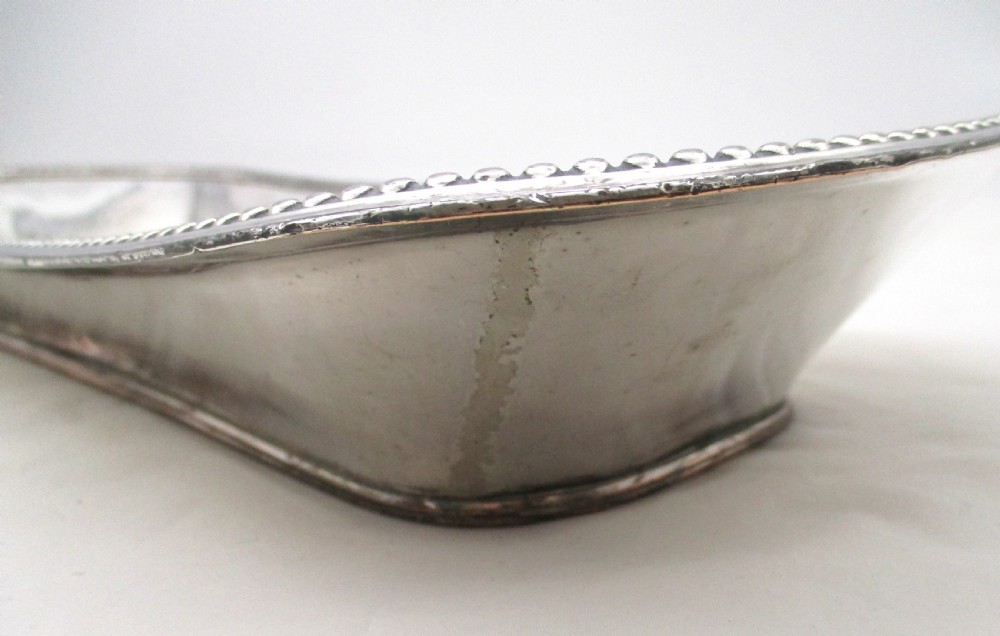 An elongated 19th-century Old Sheffield silver-plated tray featuring a rectangular form with rounded ends and a beaded outer rim. View VI