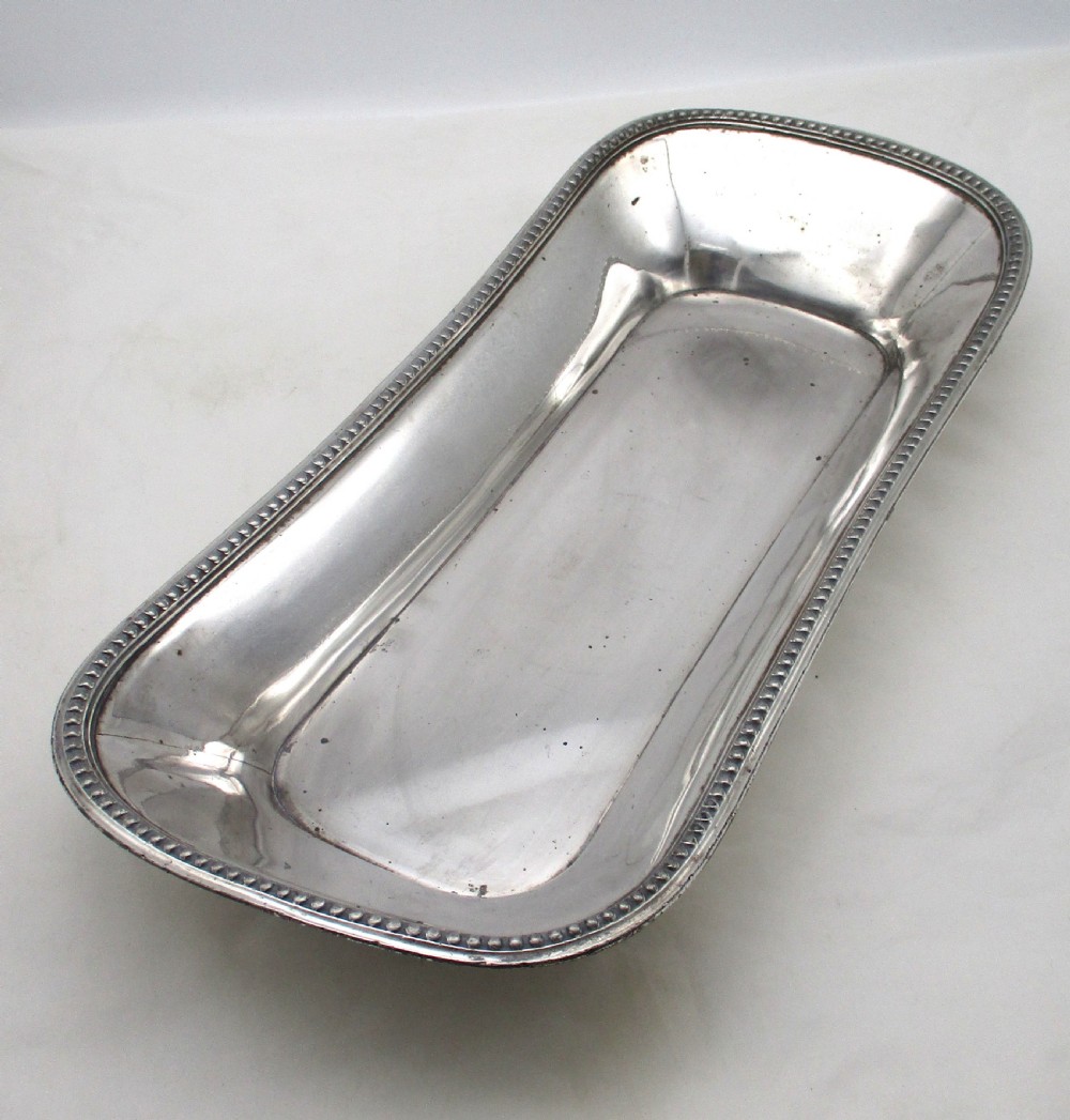 An elongated 19th-century Old Sheffield silver-plated tray featuring a rectangular form with rounded ends and a beaded outer rim. View XI
