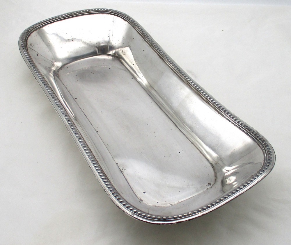 An elongated 19th-century Old Sheffield silver-plated tray featuring a rectangular form with rounded ends and a beaded outer rim. View XII