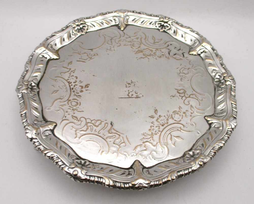 A circular Georgian Old Sheffield plated card waiter with a scalloped chased rim and etched floral scroll motifs on the surface. View III