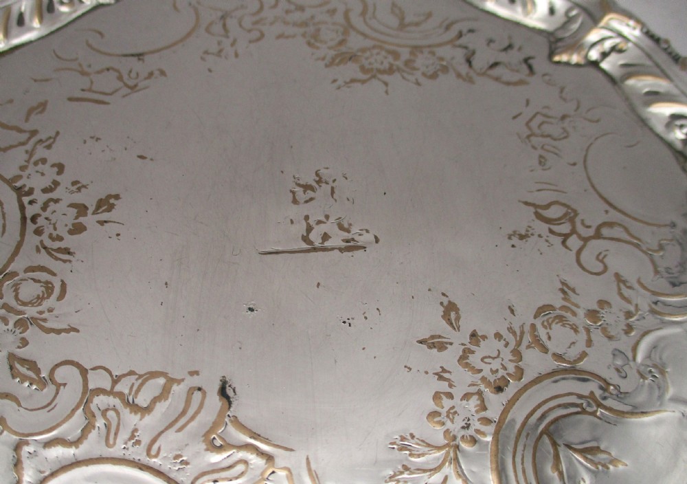 A circular Georgian Old Sheffield plated card waiter with a scalloped chased rim and etched floral scroll motifs on the surface. View IV