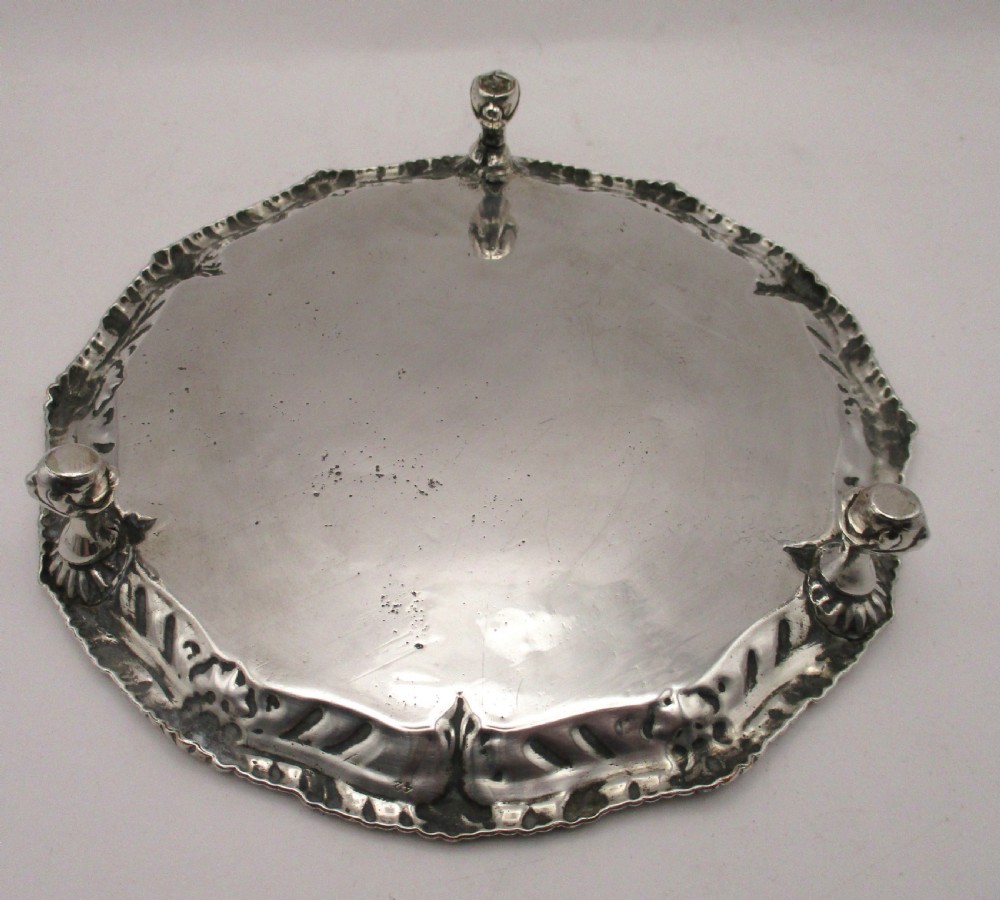 A circular Georgian Old Sheffield plated card waiter with a scalloped chased rim and etched floral scroll motifs on the surface. View VI