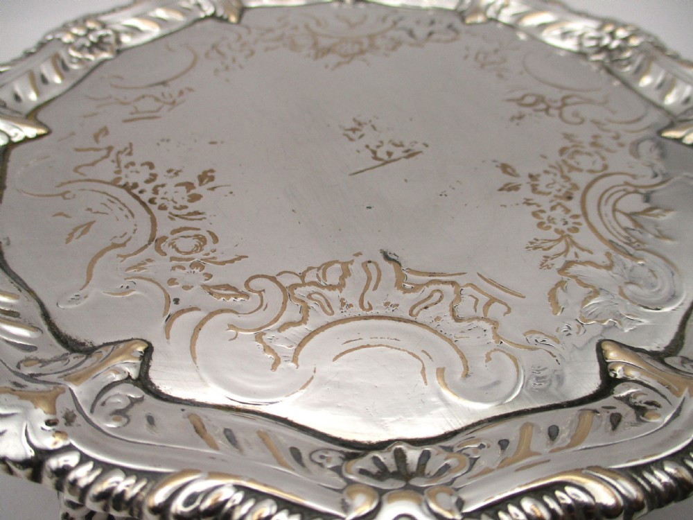 A circular Georgian Old Sheffield plated card waiter with a scalloped chased rim and etched floral scroll motifs on the surface. View VIII