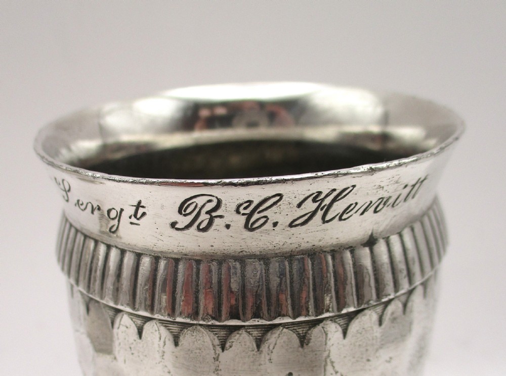 A set of four silver-plated goblets with engraved military ranks, hammered bodies, and reeded base rims. View VI