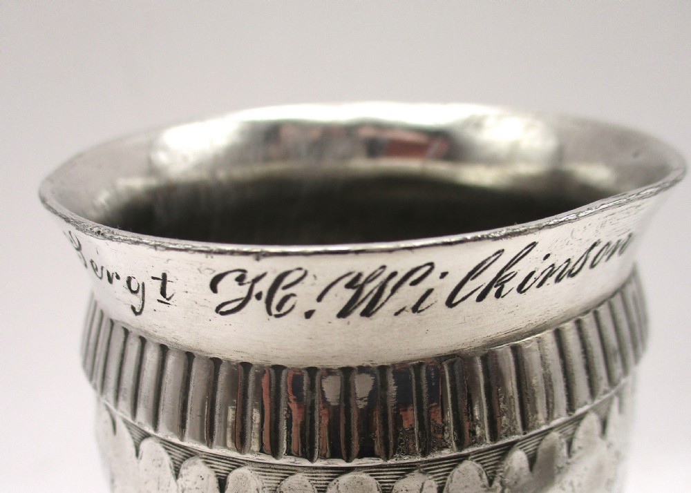 A set of four silver-plated goblets with engraved military ranks, hammered bodies, and reeded base rims. View VIII