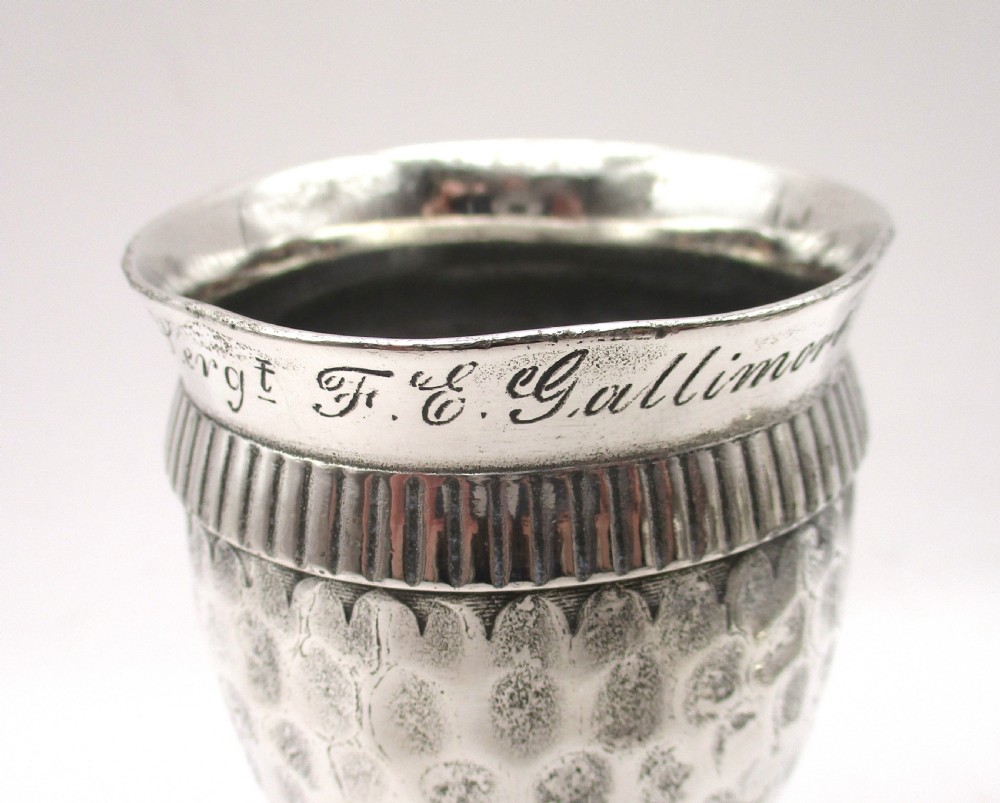A set of four silver-plated goblets with engraved military ranks, hammered bodies, and reeded base rims. View X