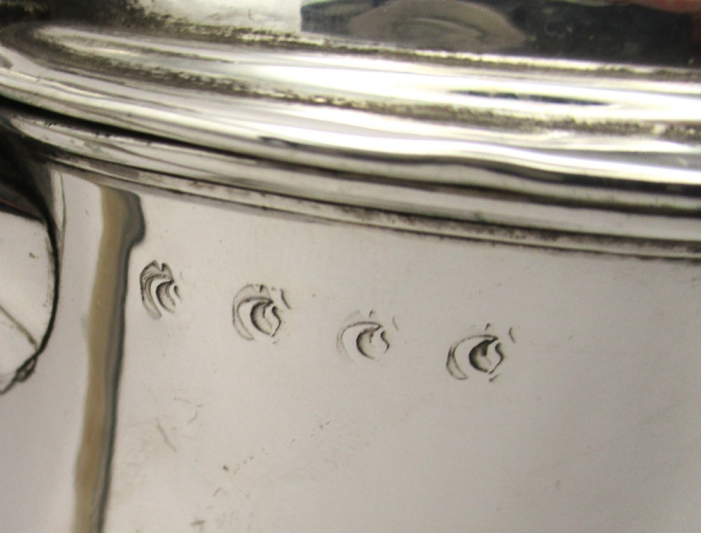 An 18th-century silver-plated beer jug with a domed hinged lid, thumbpiece, spout, and curved scroll handle. View II