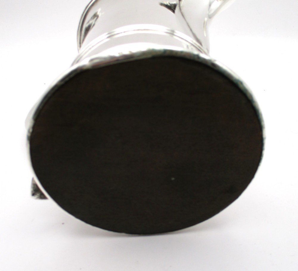 An 18th-century silver-plated beer jug with a domed hinged lid, thumbpiece, spout, and curved scroll handle. View XI