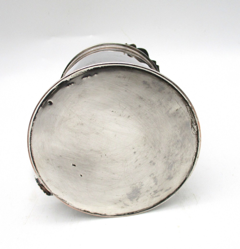 A late 18th-century silver-plated pint tankard featuring a hinged stepped lid, thumbpiece lever, curved scroll handle, and subtle copper exposure along worn rim edges. View XI