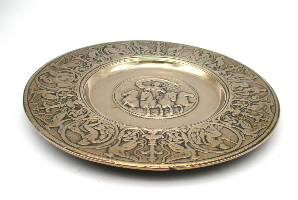A circular 19th-century bronze platter featuring a central relief of a classical chariot and an ornate outer rim detailed with mythological figures and grotesques. View III