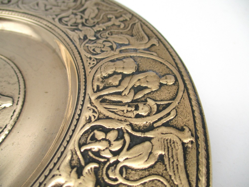 A circular 19th-century bronze platter featuring a central relief of a classical chariot and an ornate outer rim detailed with mythological figures and grotesques. View IV
