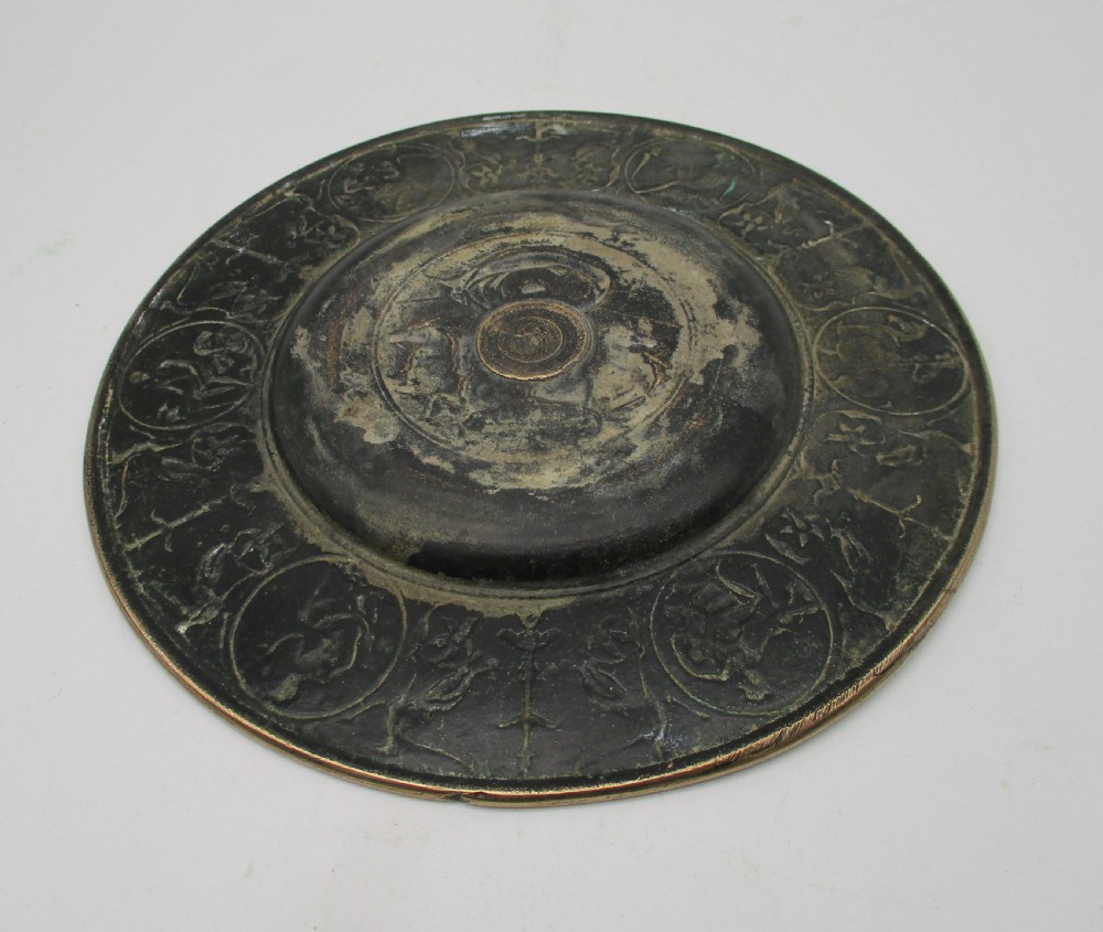 A circular 19th-century bronze platter featuring a central relief of a classical chariot and an ornate outer rim detailed with mythological figures and grotesques. View V