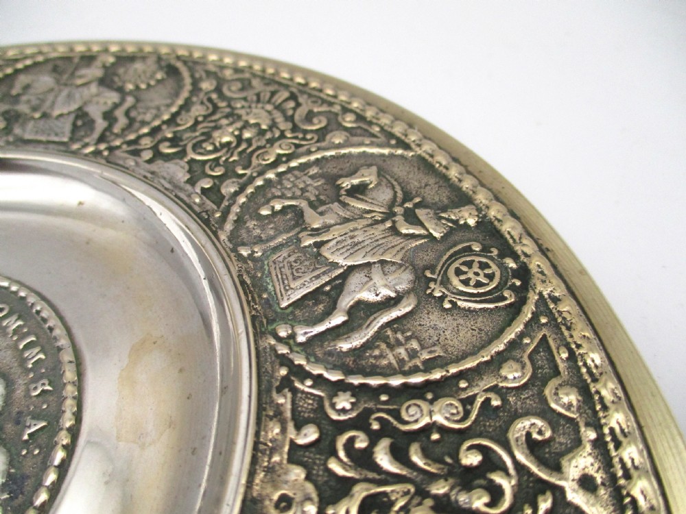 A circular 19th-century silver-plated bronze platter featuring a central relief profile of Emperor Ferdinand III on horseback surrounded by detailed equestrian vignettes and ornate scrolling foliage. View IV
