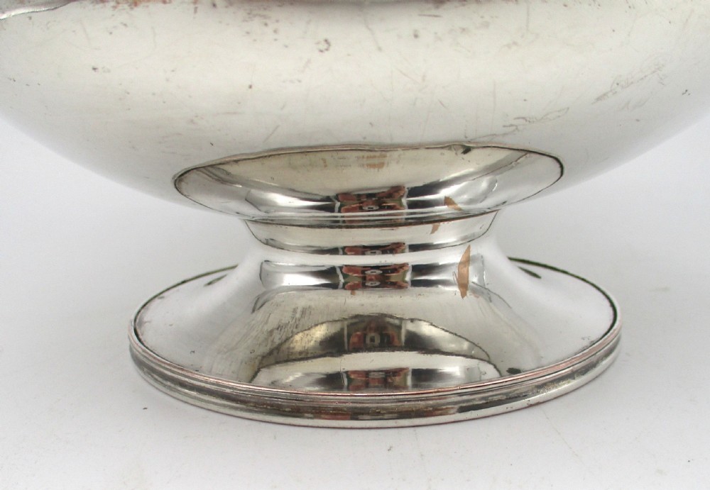 A Regency period Old Sheffield plated silver coffee pot featuring a baluster-shaped body, goose-neck spout, foliate finial, and scroll handle with heat insulators. View VII
