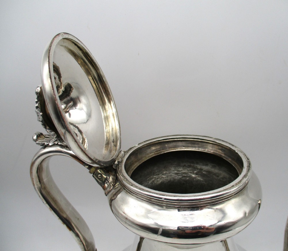 A Regency period Old Sheffield plated silver coffee pot featuring a baluster-shaped body, goose-neck spout, foliate finial, and scroll handle with heat insulators. View VIII