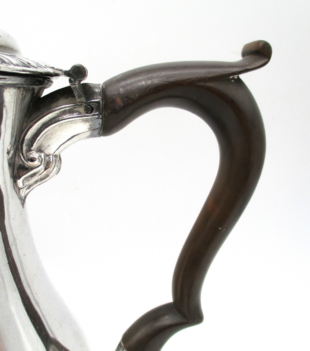 An eighteenth-century Sheffield silver-plated coffee pot featuring a baluster body, carved dark wood handle, fluted spout, and pineapple finial. View VII