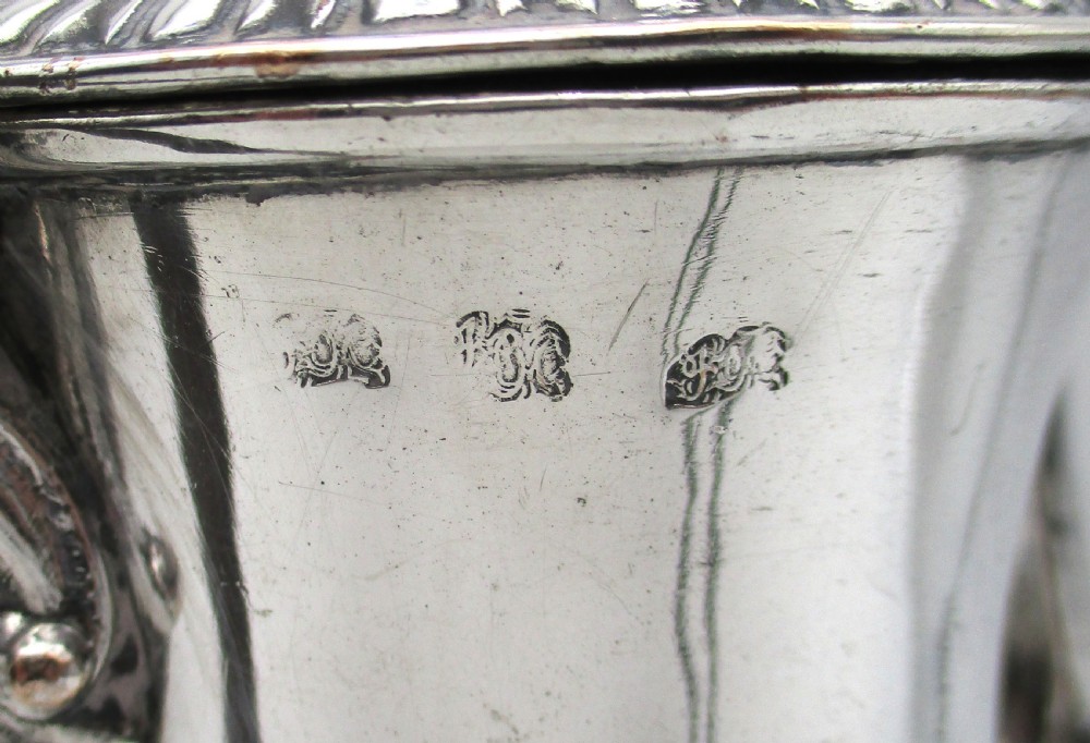 An eighteenth-century Sheffield silver-plated coffee pot featuring a baluster body, carved dark wood handle, fluted spout, and pineapple finial. View VIII