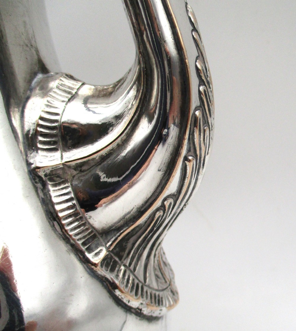 An eighteenth-century Sheffield silver-plated coffee pot featuring a baluster body, carved dark wood handle, fluted spout, and pineapple finial. View IX