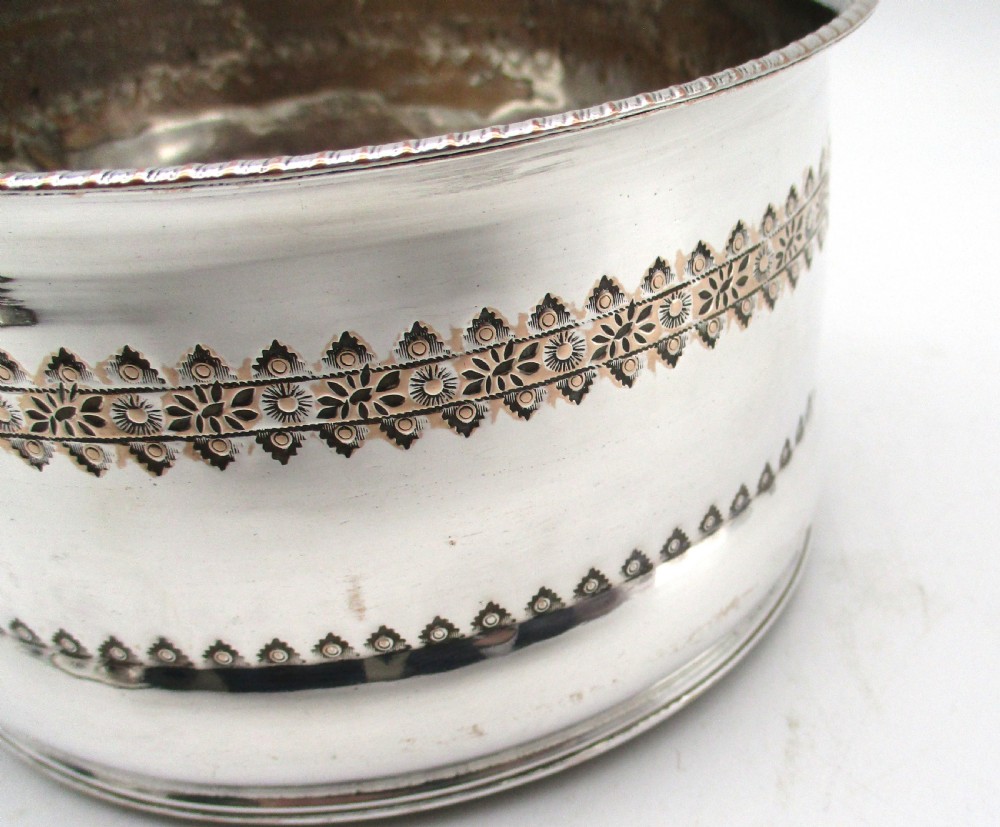 A pair of deep, circular silver-plated wine coasters featuring pierced floral decorative bands, beaded rims, and inset wooden bases. View V