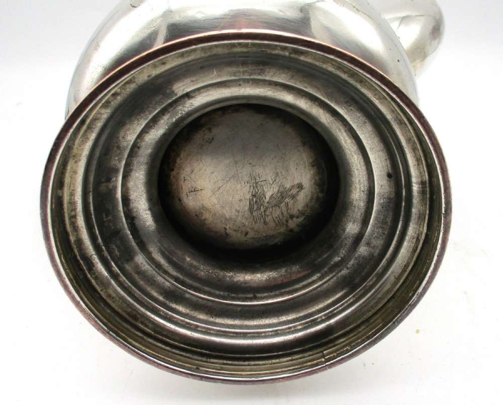 An antique Regency silver-plated coffee pot featuring a carved wooden handle, a gadrooned rim, and a stepped circular base. View VIII