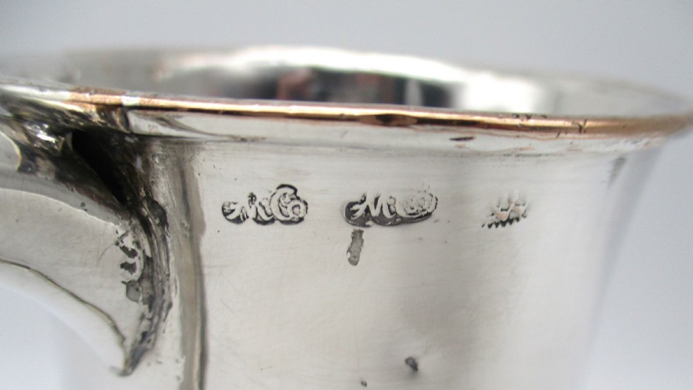 An 18th-century Old Sheffield Plate silver tankard featuring a baluster body, scroll handle, and stepped circular base. View VI