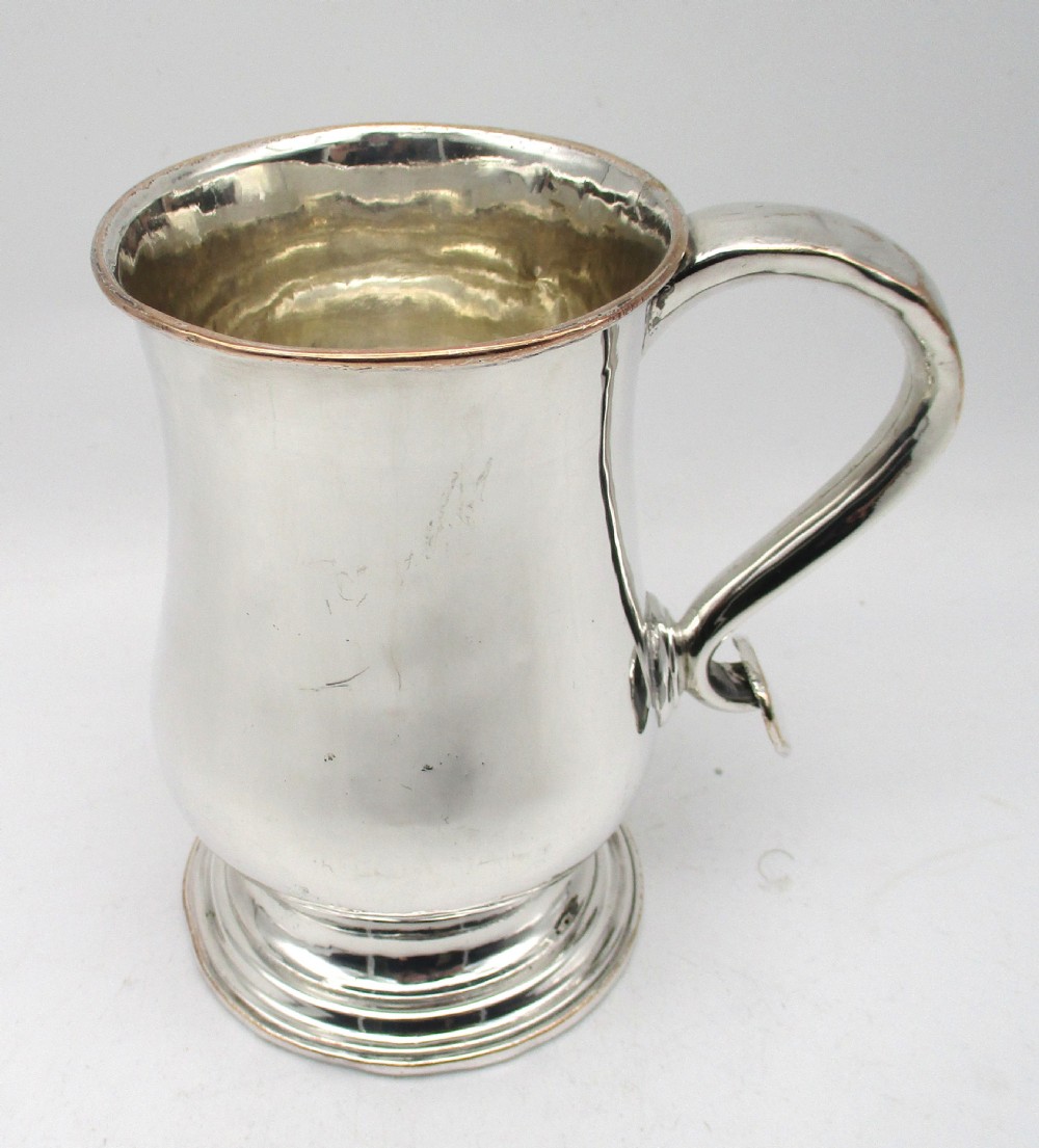 An 18th-century Old Sheffield Plate silver tankard featuring a baluster body, scroll handle, and stepped circular base. View VIII