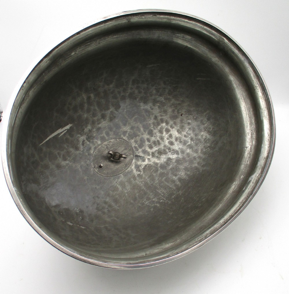 An oval Old Sheffield Plated meat dome featuring a moulded rim, an engraved crest, and a cast scrolling handle. View VII