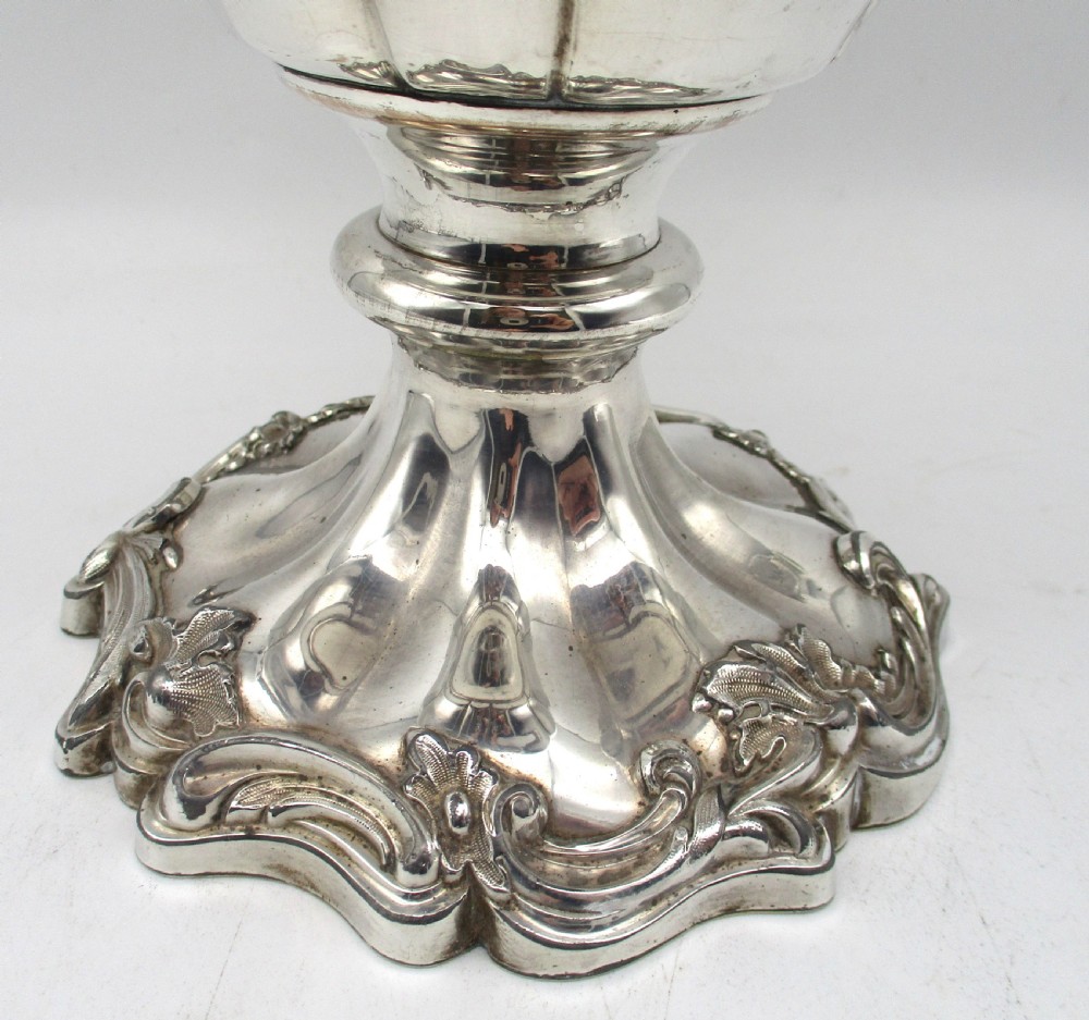 A pair of silver-plated urn-shaped wine coolers featuring scalloped foliate rims, acanthus leaf handles, and flared pedestal bases. View IV