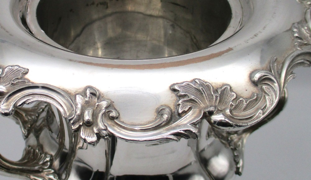 A pair of silver-plated urn-shaped wine coolers featuring scalloped foliate rims, acanthus leaf handles, and flared pedestal bases. View VII