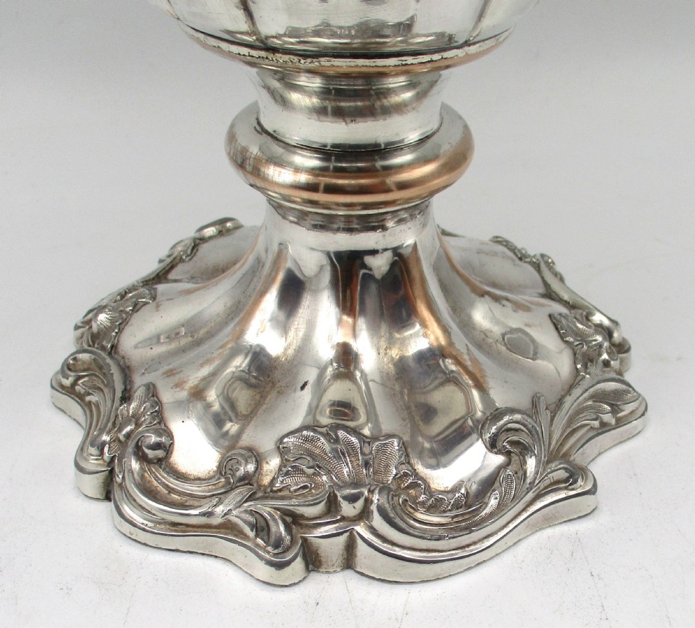 A pair of silver-plated urn-shaped wine coolers featuring scalloped foliate rims, acanthus leaf handles, and flared pedestal bases. View XIII