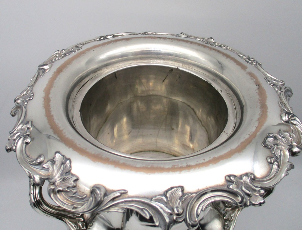 A pair of silver-plated urn-shaped wine coolers featuring scalloped foliate rims, acanthus leaf handles, and flared pedestal bases. View XIV