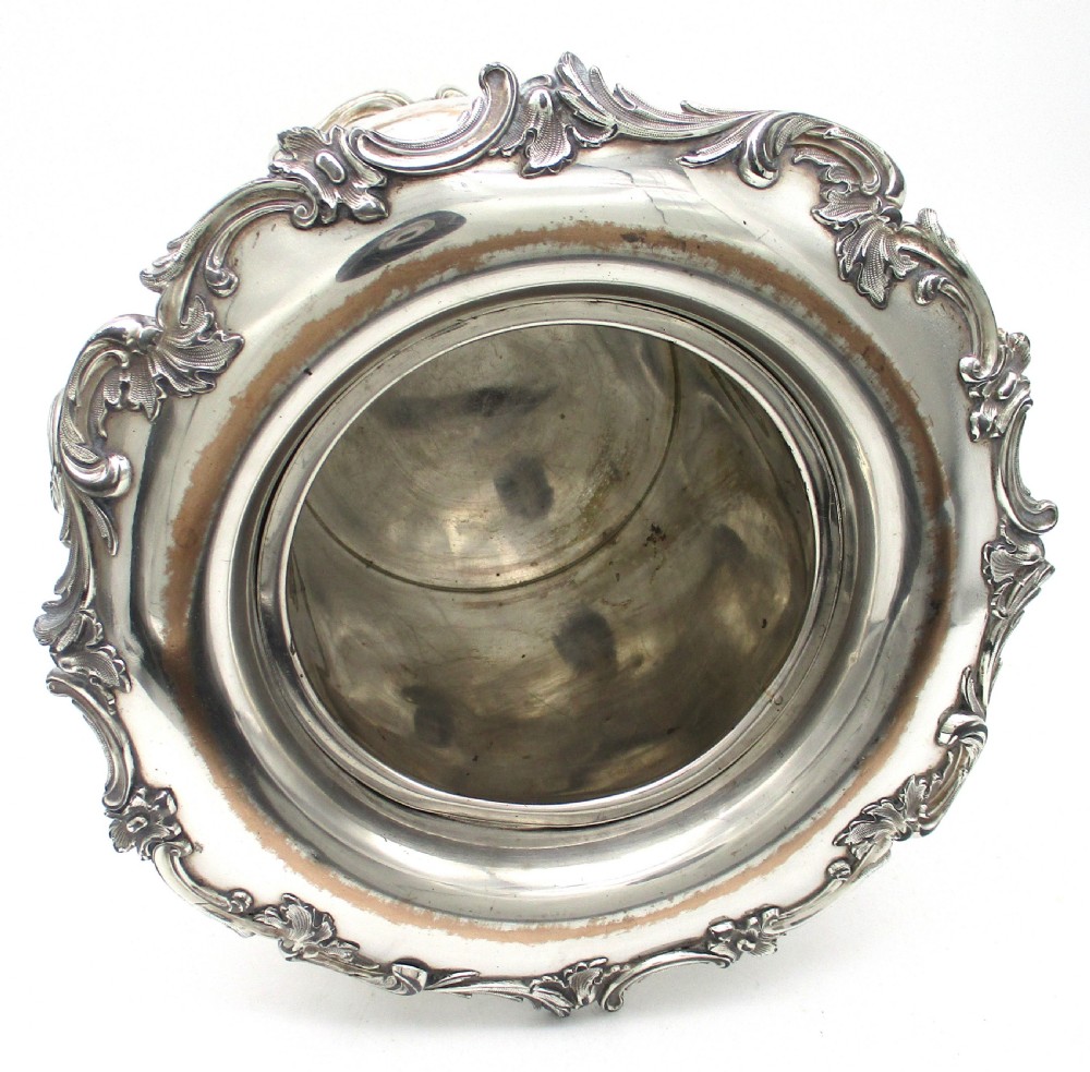 A pair of silver-plated urn-shaped wine coolers featuring scalloped foliate rims, acanthus leaf handles, and flared pedestal bases. View XVII