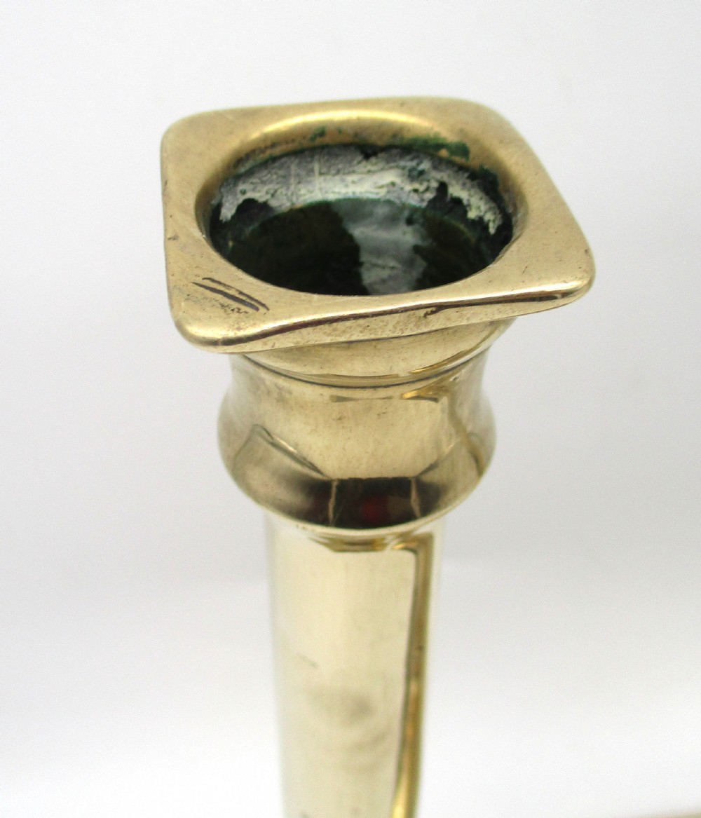 A pair of antique brass column candlesticks featuring fluted shafts and stepped square bases. View III