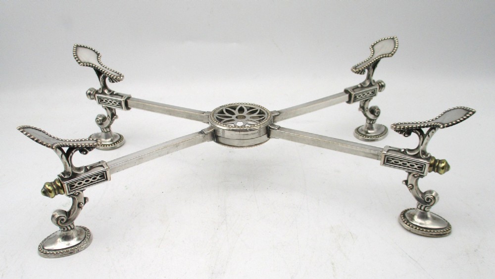 An antique Georgian Sheffield plated silver dish cross featuring four adjustable sliding arms with beaded support pads and feet.
