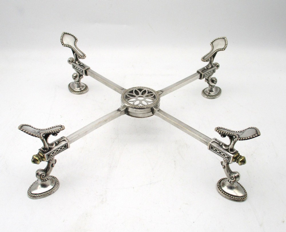 An antique Georgian Sheffield plated silver dish cross featuring four adjustable sliding arms with beaded support pads and feet. View II