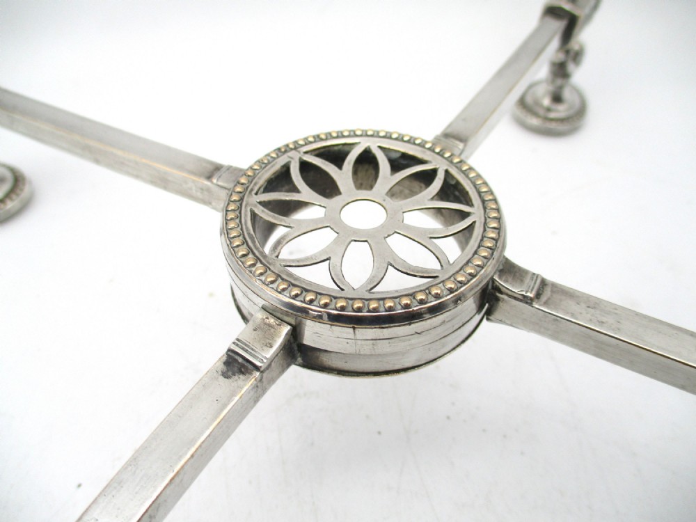 An antique Georgian Sheffield plated silver dish cross featuring four adjustable sliding arms with beaded support pads and feet. View IV