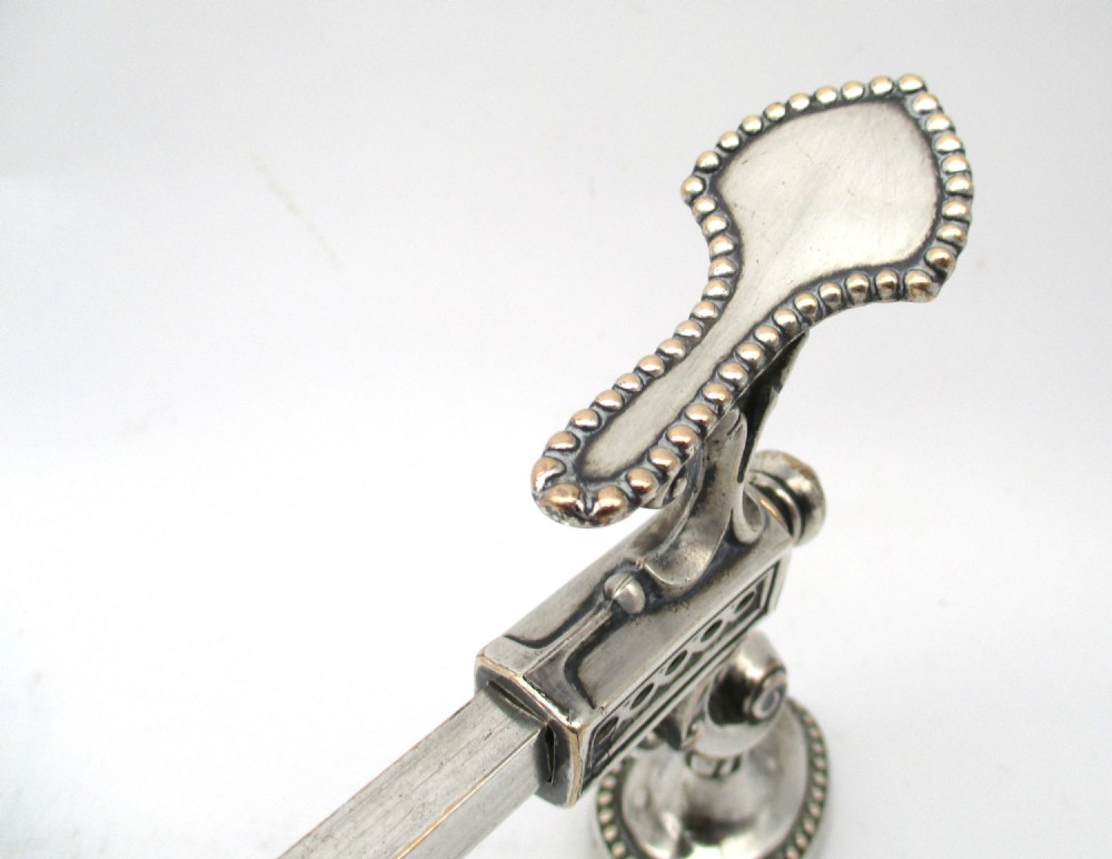 An antique Georgian Sheffield plated silver dish cross featuring four adjustable sliding arms with beaded support pads and feet. View V