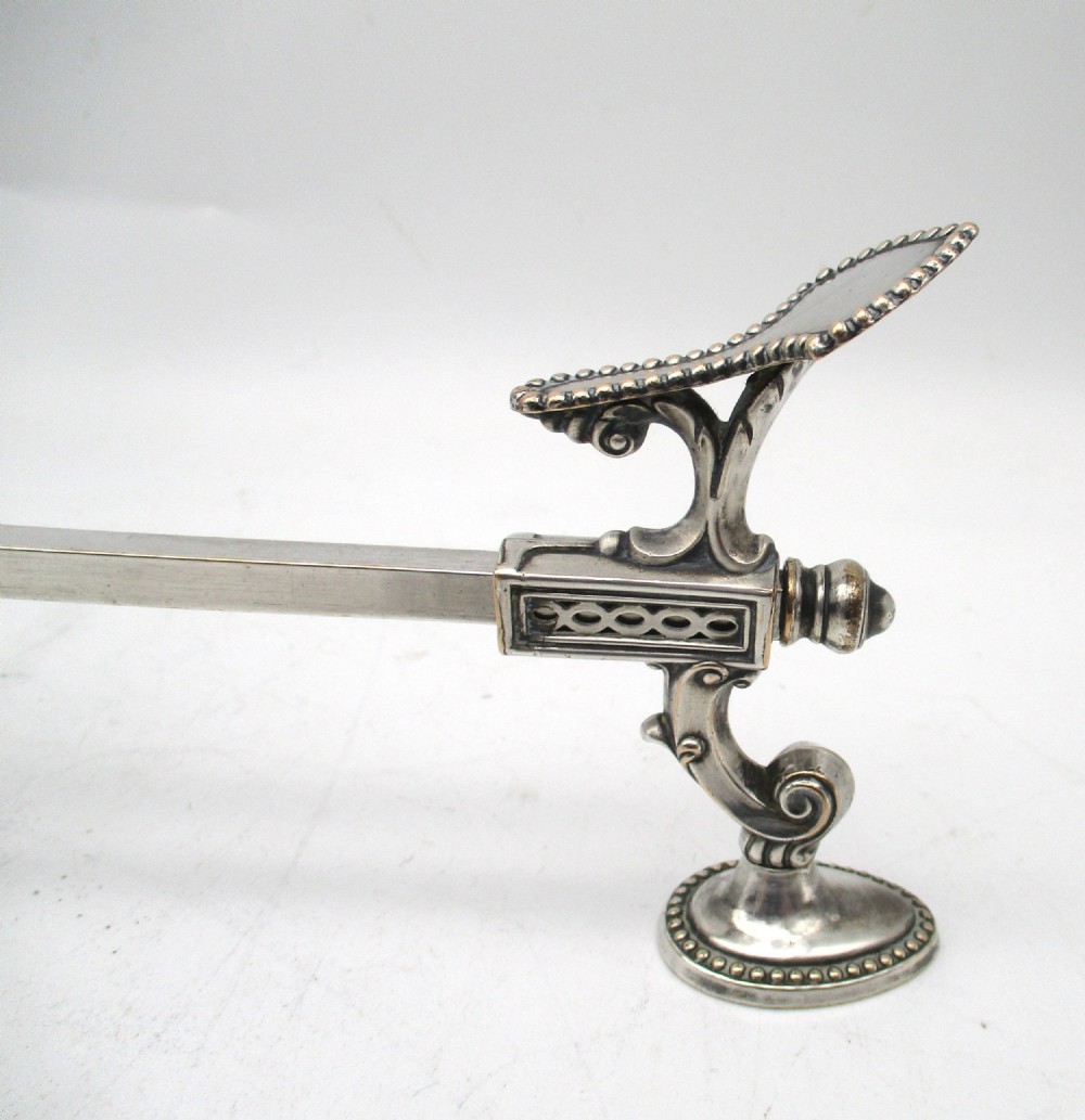 An antique Georgian Sheffield plated silver dish cross featuring four adjustable sliding arms with beaded support pads and feet. View VI